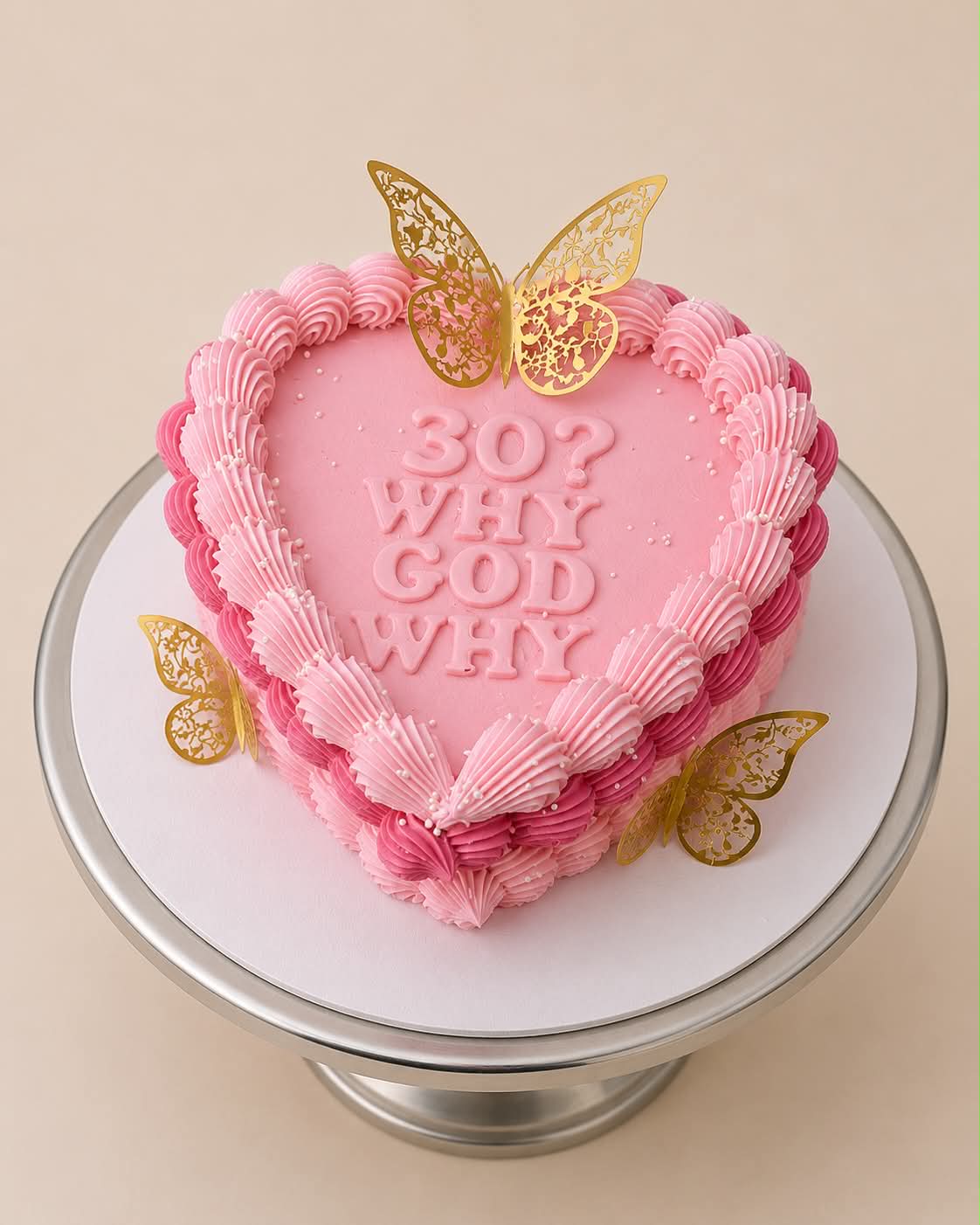 Pink heart cake reading 30? Why God Why with gold butterfly decorations